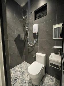 a bathroom with a toilet and a sink at Anjung Barakah Chalet in Kuala Terengganu