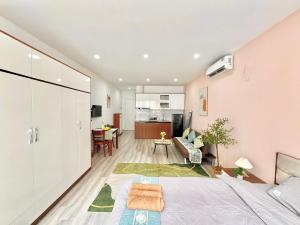 a bedroom with a bed and a living room at The Little Home - Cù Chính Lan - Modern & Comfy Apartment in Hanoi