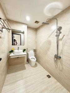 a bathroom with a toilet and a sink and a shower at The Little Home - Cù Chính Lan - Modern & Comfy Apartment in Hanoi