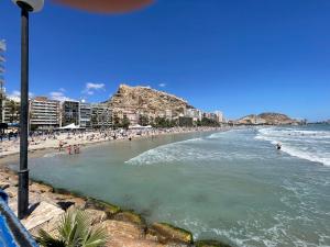 a beach with a bunch of people in the water at Casa Amarela Guesthouse, Algorfa by Primavera GuestHouses in Algorfa