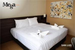 Letto o letti in una camera di Hotel Mega
