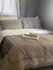 a bed with two pillows and a towel on it at Hospedagem Dona Ester in Pomerode +59 photos