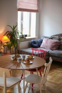 a living room with a table and chairs and a couch at Lovely central flat with soul by the river Wisła in Krakow