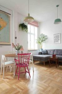 a living room with a table and a couch at Lovely central flat with soul by the river Wisła in Krakow