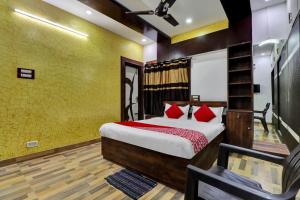 a bedroom with a bed with red pillows at Seshadri Homestay in Tirupati