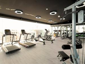 a gym with treadmills and machines in a building at VESTA - Dubai Residence in Dubai