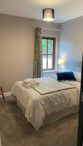 a bedroom with a large bed with a window at Creevagh Cottage in Castlebar