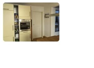 a kitchen with white appliances and a mirror at Feel Like Home - MeTime2 in Frielendorf