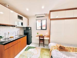 a kitchen with a bed and a sink in a room at The Little Home - Cù Chính Lan - Modern & Comfy Apartment in Hanoi +35 photos
