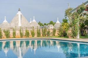 a swimming pool in front of a building at Villa Caramia in Locorotondo