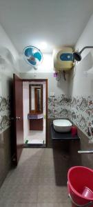a bathroom with a toilet and a sink and a mirror at Hotel Kashyaam Inn in Varanasi