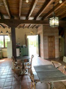 a dining room with a wooden table and chairs at Posada El Jardin de Angela in Santander