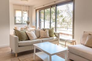 a living room with a couch and a table at Camping Relax Sol in Torredembarra