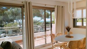 a living room with a table and a large window at Camping Relax Sol in Torredembarra