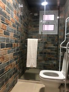 a bathroom with a brick wall and a toilet at Dahab Relax Studio 2 in Dahab