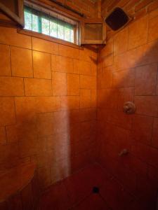 a bathroom with a tiled shower with a window at 2 bedroom apartment in lush garden, 3 blocks from beach and center of San Juan in San Juan del Sur