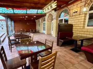 a restaurant with tables and chairs and a stained glass ceiling at HOSTAL-RESTAURANTE POSADA DEL DUQUE in Villalbilla de Burgos