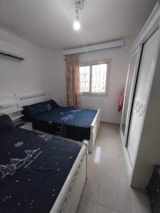 a bedroom with two beds and a window at TAVIRA Rass Suder"For Family" in Ras Matarma +37 photos