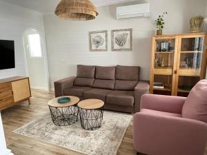a living room with a couch and two tables at Villa Suérte del Mar in Torrevieja