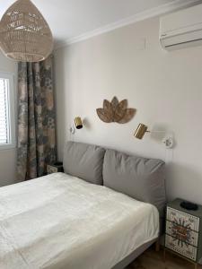 a bedroom with a bed with a white bedspread at Villa Suérte del Mar in Torrevieja