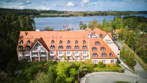 an aerial view of a large building with a lake at Strandhotel Seehof in Langlau
