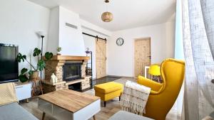 a living room with a couch and a fireplace at Siedlisko nad Starym Reskiem in Stare Resko