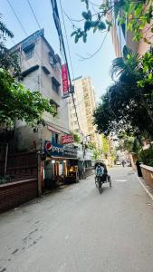 a street with a motorcycle parked on the side of the road at Hotel Image Residential Near Square Hospital in Dhaka
