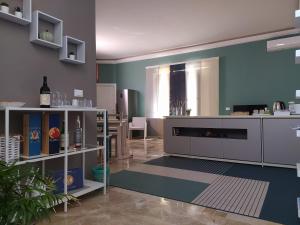 a living room with a kitchen with blue walls at Sole di Maggio in Marsala