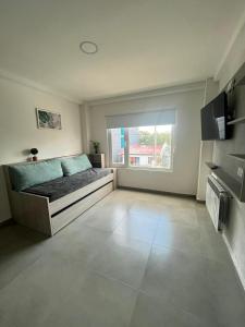 a bedroom with a bed and a large window at Apart Goleta Florencia in Ushuaia