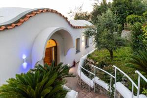 an external view of a house with a stairway at My Exclusive Italy - Elegant Villa in Anacapri Infinity Pool & Design in Anacapri