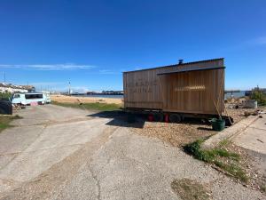 a shipping container sitting on the side of a road at Stunning 2-Bed Apartment in Shoreham-by-Sea in Shoreham-by-Sea