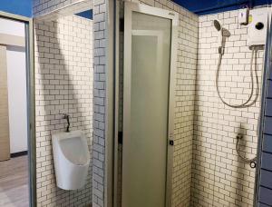 a bathroom with a urinal on the wall at Skylark bangkok 云雀 in Bangkok