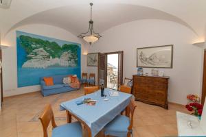 a living room with a blue table and chairs at Casa Stella di mare in Positano
