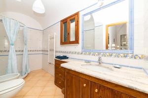 a bathroom with a sink and a toilet at Casa Stella di mare in Positano +13 photos