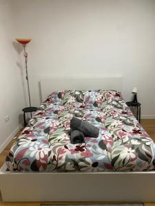 a bedroom with a bed with a flower patterned bedspread at Allen easyLoft in Trieste