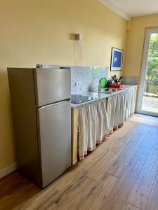 a kitchen with a stainless steel refrigerator and a counter at Libeccio 1 - Holiday Home Lerici in Lerici