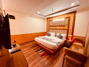 1 dormitorio con 1 cama y 1 silla en Kawayat INN, en Bhavnagar