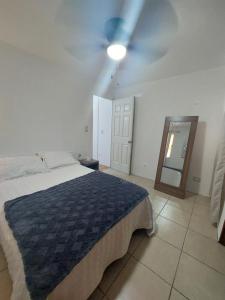 1 dormitorio con 1 cama y ventilador de techo en Depto con clima y estacionamiento frente 25 IMSS en Monterrey