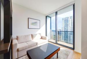 a living room with a couch and a large window at Incredible High-Floor Studio with Bay Views in Miami