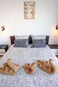 a bedroom with a bed with two pairs of slippers at Amazing 2 bedroom flat with Beachfront and Pool, Paraíso del Sur A306 in Playa Paraiso
