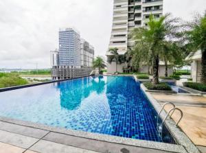 a large swimming pool with blue water in front of a building at Meridin Medini Near Legoland 5min in Johor Bahru