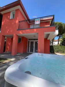 a house with a hot tub in front of it at Principesse in Rosolina Mare