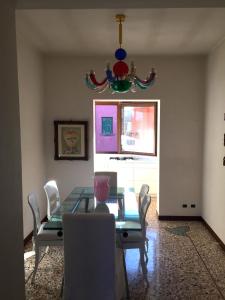 a dining room with a glass table and chairs at Elegante affascinante Appartamento in centro storico in Caorle +10 photos