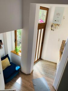 a living room with a blue couch and a door at Charming Central Apartments in Cluj-Napoca
