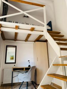 a room with a desk and a loft bed at Charming Central Apartments in Cluj-Napoca