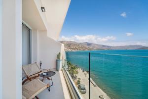 a balcony with a view of the water at Ocean Rythm Elounda Suite in Elounda