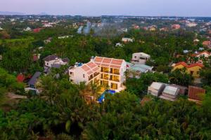 an aerial view of a house in the trees at Én Mansion Hoi An in Hiếu Nhơn