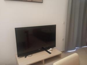 a flat screen tv sitting on a stand in a living room at Apartmani Marko & Joso in Biograd na Moru