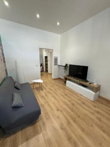 a living room with a couch and a flat screen tv at Appartamento Eden Green in Sulmona