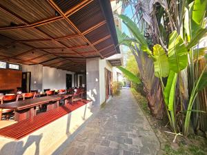 a patio with tables and chairs and a building at En Retreat Villa Hoi An in Hiếu Nhơn